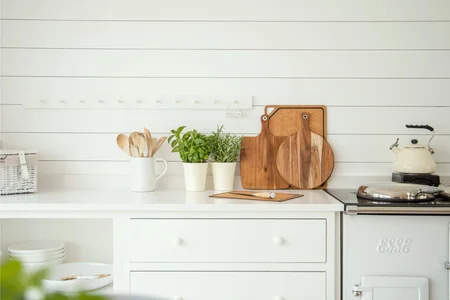Potted herbs placed near an apartment kitchen for easy harvesting